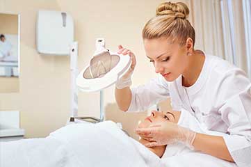 Skin Care Specialist examining skin